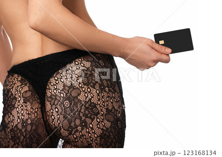 woman in lingerie underwear holding black premium credit bank card on white background. payment online woman in lingerie underwear holding black premium credit bank card on white background. payment online 123168134