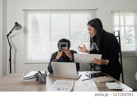 Business professional expressing frustration while discussing project issues with a colleague at the office. Business professional expressing frustration while discussing project issues with a colleague at the office. 123168361