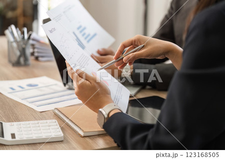 Professionals engaged in a detailed analysis of financial reports and strategies. Professionals engaged in a detailed analysis of financial reports and strategies. 123168505