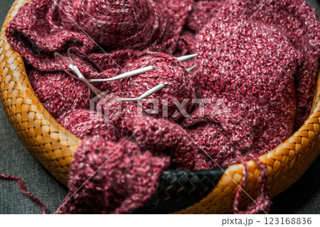 yarns, knitting needles and pattern sample in basket on sofa. yarns, knitting needles and pattern sample in basket on sofa. 123168836