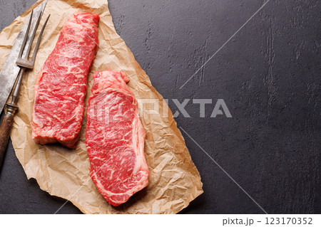 Raw marbled striploin steak, fresh, rich, ready for cooking Raw marbled striploin steak, fresh, rich, ready for cooking 123170352