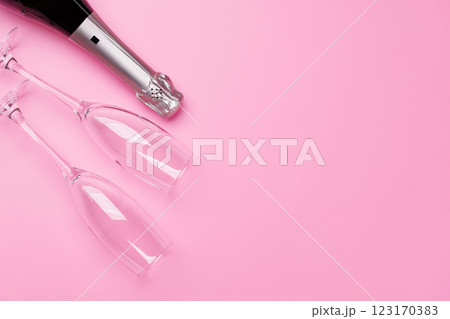 A stylish champagne bottle with elegant glasses on a soft pink background A stylish champagne bottle with elegant glasses on a soft pink background 123170383