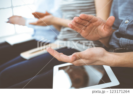 Business people clapping at meeting or conference, close-up of hands. Group of unknown businessmen and women in modern white office. Success teamwork, corporate coaching and applause concept Business people clapping at meeting or conference, close-up of hands. Group of unknown businessmen and women in modern white office. Success teamwork, corporate coaching and applause concept 123171264