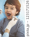 Cute arab boy sitting at dental chair with open mouth during oral checking up with doctor. Visiting sunny dentist office 123171526