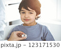 Doctor-woman examining a child patient by stethoscope in sunny clinik. Medicine concept 123171530