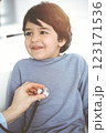 Doctor-woman examining a child patient by stethoscope in sunny clinik. Medicine concept 123171536