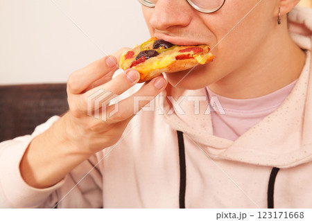 Bearded Caucasian white mature male in pink t-shirt eating delicious pizza slices Bearded Caucasian white mature male in pink t-shirt eating delicious pizza slices 123171668