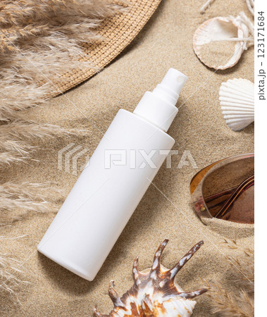 White spray bottle, sunglasses, pampas grass and seashells on a sand, Sunscreen cosmetic mockup 123171684