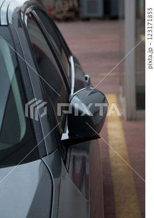 Side view of a luxury gray sedan model car from 2024 production, folding mirror details Side view of a luxury gray sedan model car from 2024 production, folding mirror details 123171855