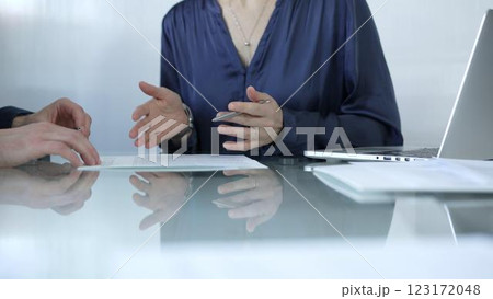 Business colleagues analyzing financial data and collaborating on a project during a productive office meeting while sitting at the glass table. Businesspeople concept Business colleagues analyzing financial data and collaborating on a project during a productive office meeting while sitting at the glass table. Businesspeople concept 123172048