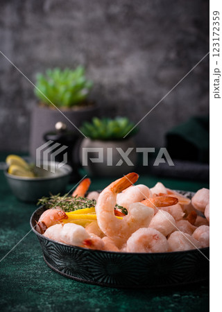Frozen uncooked prawns or shrimps with lemon Frozen uncooked prawns or shrimps with lemon 123172359