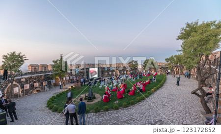 People are enjoying the open air cinema in the historic building at evening timelapse People are enjoying the open air cinema in the historic building at evening timelapse 123172852