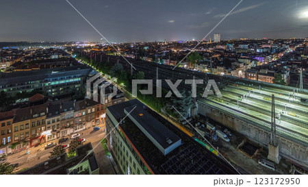Aerial night timelapse of Brussels North station railway tracks with trains arriving and departing. Belgium 123172950