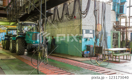 Conveyor assembly stage the body of tractor at big industrial factory timelapse 123173040