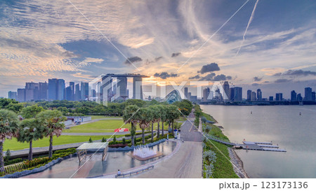 Marina Bay Sands, Gardens by the bay with cloud forest, flower dome and supertrees at sunset timelapse 123173136