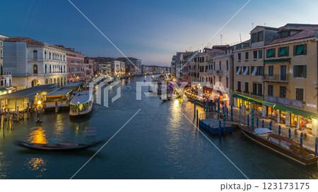 Grand Canal in Venice, Italy day to night timelapse. Gondolas and city lights from Rialto Bridge. Grand Canal in Venice, Italy day to night timelapse. Gondolas and city lights from Rialto Bridge. 123173175