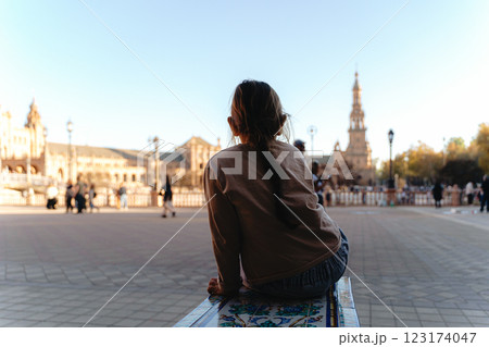 Young caucasian female child girl enjoying scenic view of historic plaza on a sunny day, plaza de 123174047