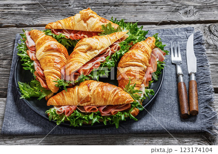 croissant sandwiches with ham and lettuce on plate croissant sandwiches with ham and lettuce on plate 123174104