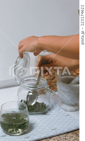 Preparing dried moringa leaves or moringa oleifera to make tea, a traditional natural alternative medicine and health supplement Preparing dried moringa leaves or moringa oleifera to make tea, a traditional natural alternative medicine and health supplement 123174621