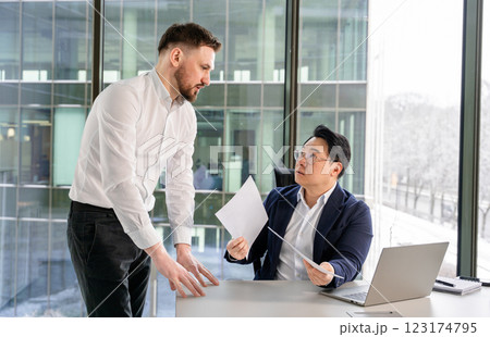Professional Discussion Between Two Businessmen in a Modern Office Setting 123174795