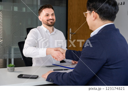 Business Professionals Shaking Hands During a Meeting in a Modern Office Business Professionals Shaking Hands During a Meeting in a Modern Office 123174821