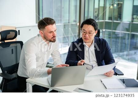 Professional Business Discussion Between Two Colleagues in a Modern Office Professional Business Discussion Between Two Colleagues in a Modern Office 123174935