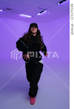 Young dancer performs energetic routine in brightly lit studio Young dancer performs energetic routine in brightly lit studio 123175190