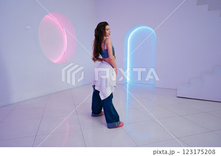 Elegant pose of a model in a modern, brightly lit studio space 123175208