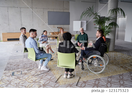 Corporate business team meeting with a manager or coach. Group of happy diverse, multiracial people sitting in a circle Corporate business team meeting with a manager or coach. Group of happy diverse, multiracial people sitting in a circle 123175323