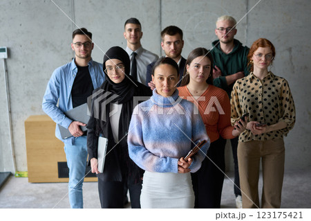 A diverse and determined team of business professionals stands confidently in an office, ready to tackle new business plans and challenges with a focus on success and growth A diverse and determined team of business professionals stands confidently in an office, ready to tackle new business plans and challenges with a focus on success and growth 123175421