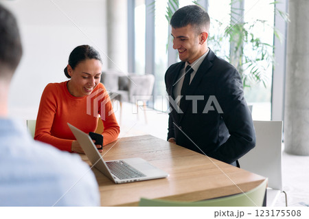 A young, diverse business team sitting together in a modern office, exchanging ideas and business plans, fostering collaboration and innovation for future success. A young, diverse business team sitting together in a modern office, exchanging ideas and business plans, fostering collaboration and innovation for future success. 123175508
