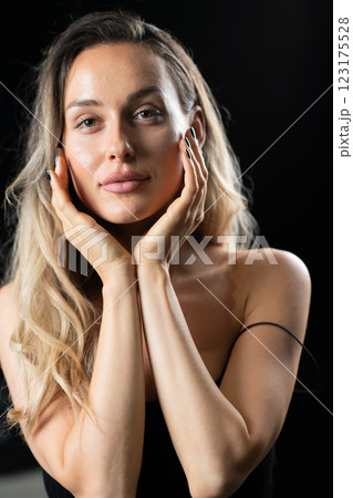 Radiant Elegance: A Stunning Blonde in a Black Dress Exuding Confidence and Beauty. 123175528