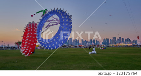 Qatar Kite Festival 2025 in Old Doha port (Mina District) sunset shot showing spectacular showcase of colorful kites soaring across the Doha skyline Qatar Kite Festival 2025 in Old Doha port (Mina District) sunset shot showing spectacular showcase of colorful kites soaring across the Doha skyline 123175764