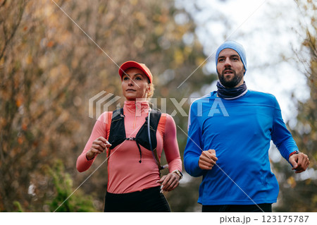 Happy Couple Running on a Forest Trail 123175787
