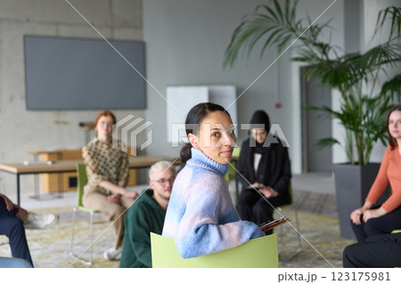 A diverse group of business professionals sits attentively in a modern office, actively participating in a training session led by an instructor, focusing on the latest technological advancements in A diverse group of business professionals sits attentively in a modern office, actively participating in a training session led by an instructor, focusing on the latest technological advancements in 123175981