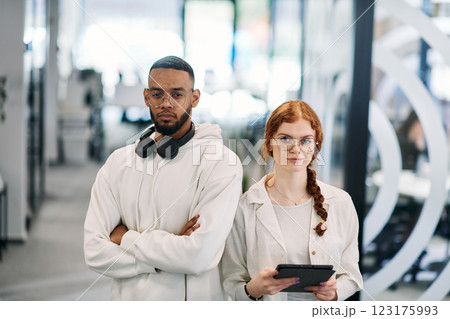 In a modern office African American businessman and his businesswoman colleague, with her striking orange hair, engage in collaborative problem-solving sessions In a modern office African American businessman and his businesswoman colleague, with her striking orange hair, engage in collaborative problem-solving sessions 123175993