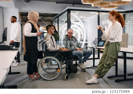 Young group of business people brainstorming together in a startup space, discussing business projects, investments, and solving challenges Young group of business people brainstorming together in a startup space, discussing business projects, investments, and solving challenges 123175994