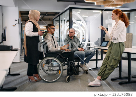 Young group of business people brainstorming together in a startup space, discussing business projects, investments, and solving challenges 123176088