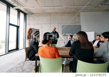A diverse multiethnic business team engages in a collaborative meeting, discussing strategies and solutions in a modern office setting 123176375