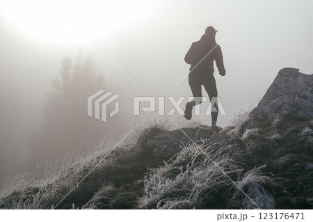 Trail Runner in Misty Mountain Landscape Trail Runner in Misty Mountain Landscape 123176471
