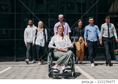 A diverse and confident group of businessmen posing together, with a businesswoman in a wheelchair radiating success, ambition, and unity, capturing the essence of a dynamic and inspiring business A diverse and confident group of businessmen posing together, with a businesswoman in a wheelchair radiating success, ambition, and unity, capturing the essence of a dynamic and inspiring business 123176477