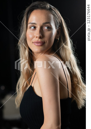 Radiant Elegance: A Stunning Blonde in a Black Dress Exuding Confidence and Beauty. 123176644