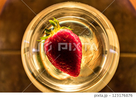Strawberry floating inside a wine glass top view Strawberry floating inside a wine glass top view 123176876