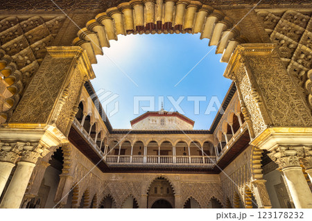 The Alcazar of Seville, historic royal palace in Seville town, Andalusia, Spain. Intricate architecture of a historic courtyard. Ornate arches and detailed stonework create a stunning visual. 123178232
