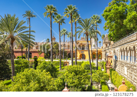 The Alcazar of Seville, historic royal palace in Seville town, Andalusia, Spain. Sun-drenched palace gardens with palm trees and lush greenery. A tranquil oasis. The Alcazar of Seville, historic royal palace in Seville town, Andalusia, Spain. Sun-drenched palace gardens with palm trees and lush greenery. A tranquil oasis. 123178275