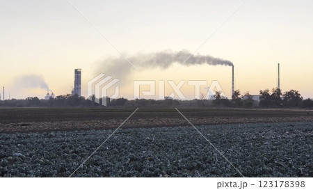 Heavy gray smoke is poured from the chimney pipes of thermal power plant. Carbon dioxide emitting from chimneys from industrial factory into the atmosphere. Concept of environmental pollution problem Heavy gray smoke is poured from the chimney pipes of thermal power plant. Carbon dioxide emitting from chimneys from industrial factory into the atmosphere. Concept of environmental pollution problem 123178398