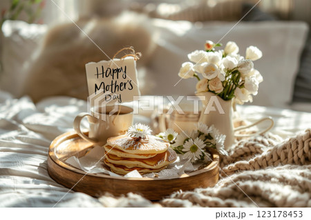 Mothers Day breakfast in bed with pancakes and flowers Mothers Day breakfast in bed with pancakes and flowers 123178453