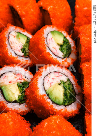 Delicious Fresh Sushi Rolls Presenting Exquisitely on a Black Background Delicious Fresh Sushi Rolls Presenting Exquisitely on a Black Background 123178809