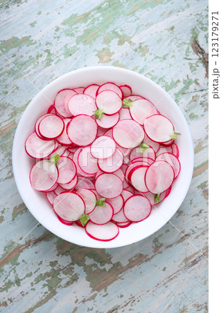 Fresh radish salad with thin slices on a white plate 123179271
