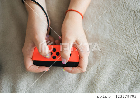 Woman playing on the video game console. Holding hands gamepad, game controller 123179703